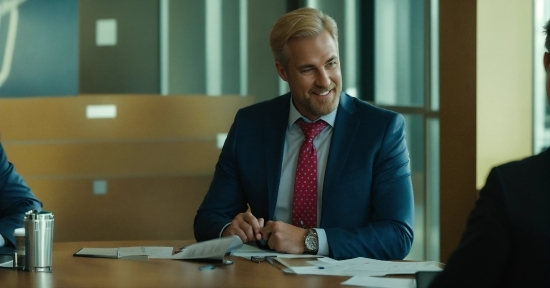 Microphone, Tie, Smile, Table, Spokesperson, Suit