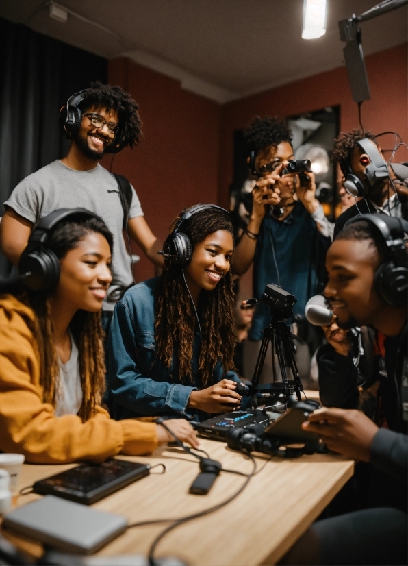 Table, Videographer, Smile, Desk, Eyewear, Audio Equipment