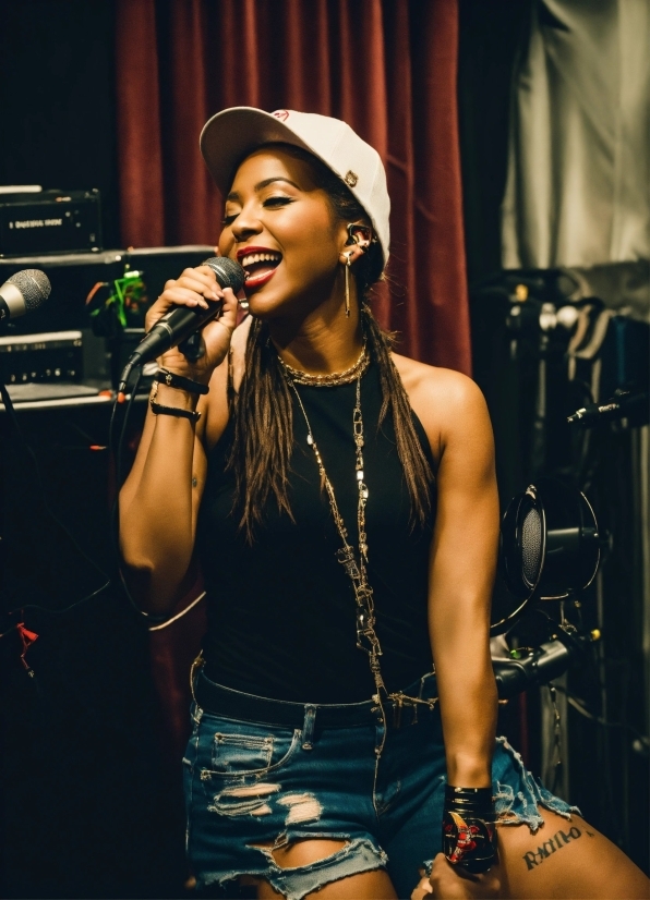 Microphone, Lip, Hairstyle, Smile, Muscle, Musician